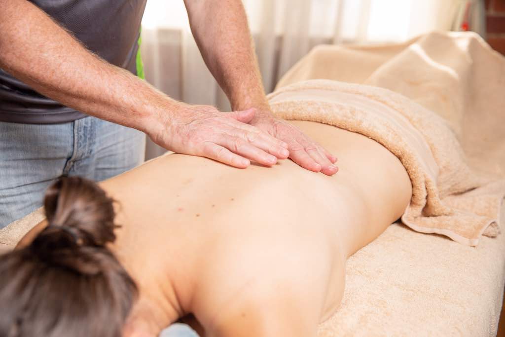 massage therapist using elbows for deep tissue massage